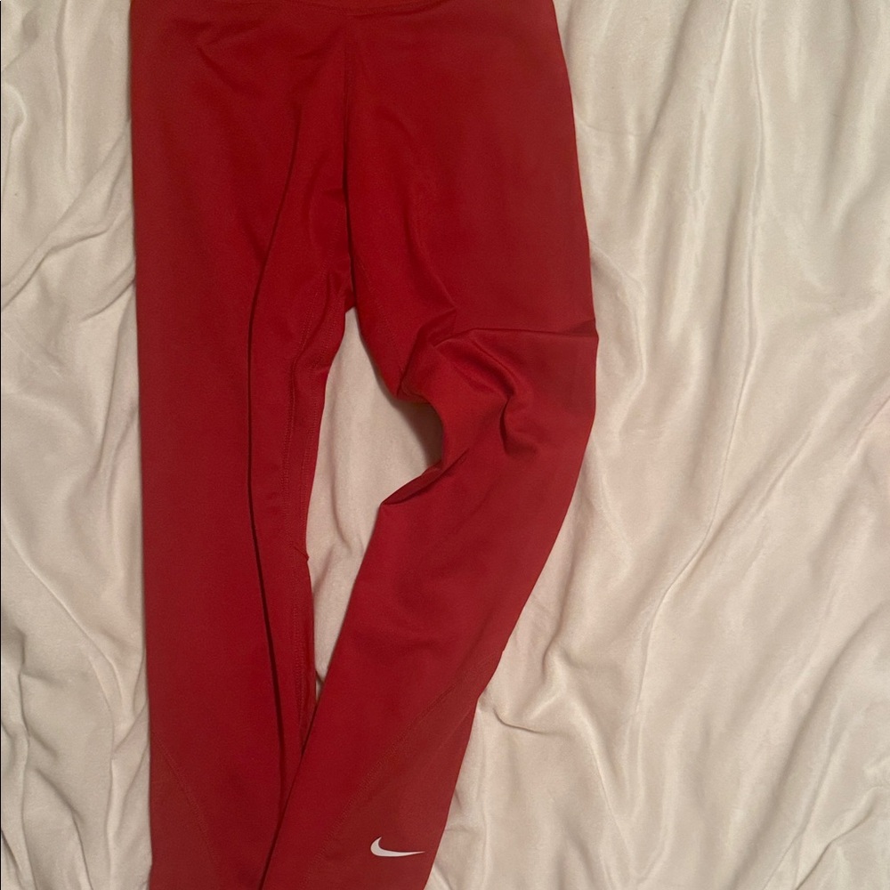 Nike brick red leggings with mesh on the bottom leg!